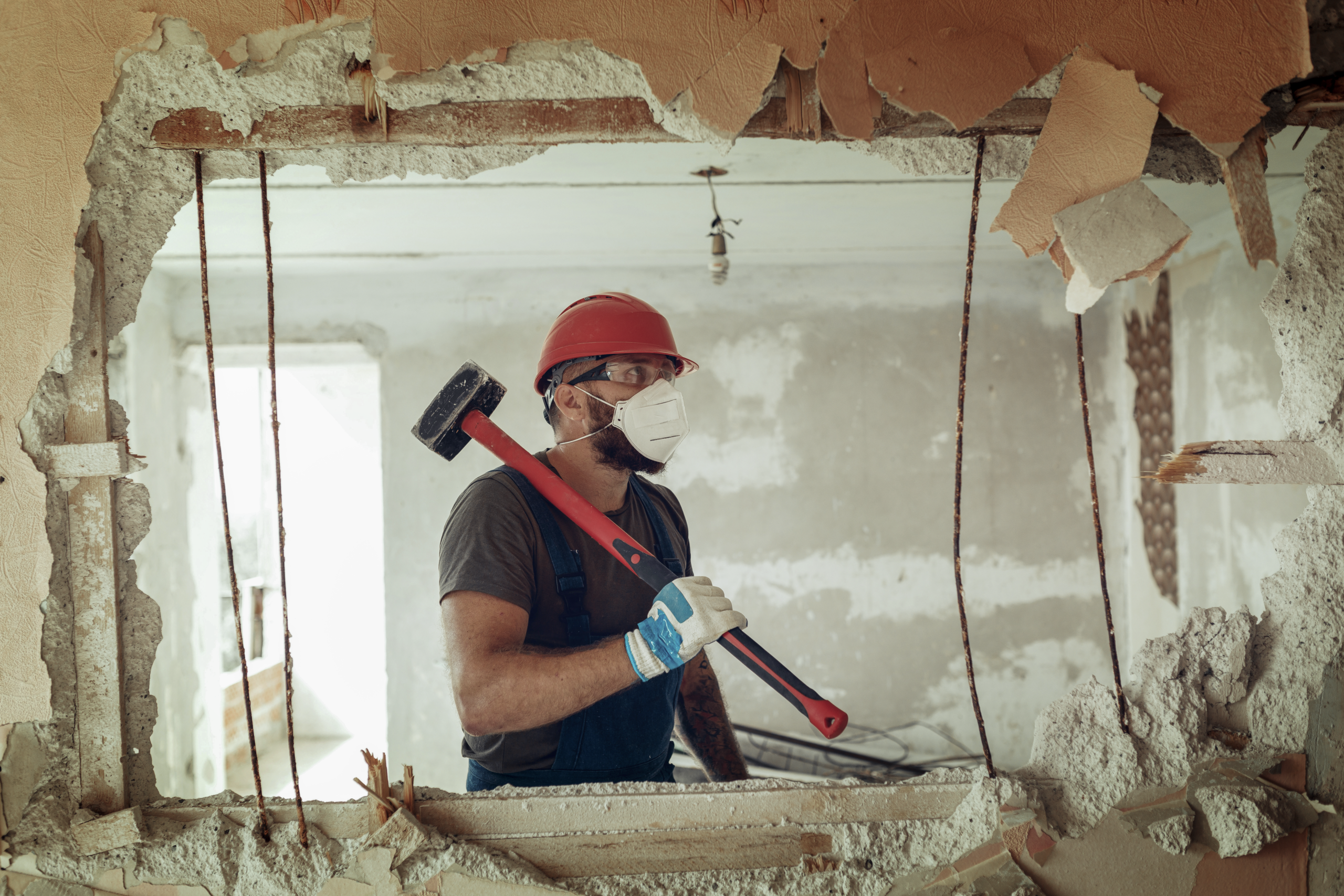Homeowners reviewing renovation plans and estimating the total cost of a home improvement project at a kitchen table.